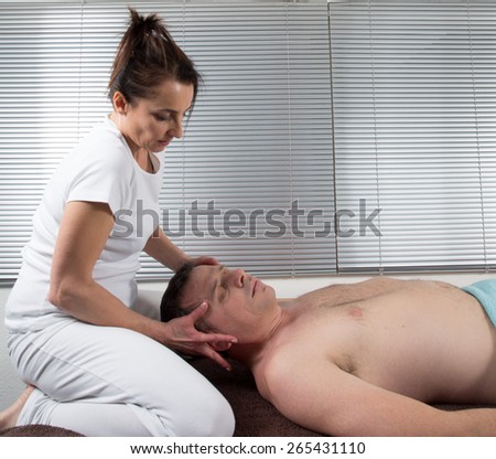 A man Receiving Shiatsu Treatment From a woman therapist