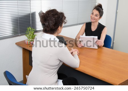 A Business woman receives candidate for  a job at her office