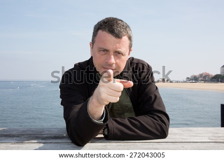 Attractive  man pointing a finger towards you