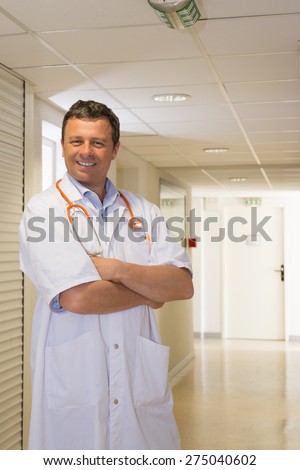 Male doctor standing and waiting for his patient at hospital