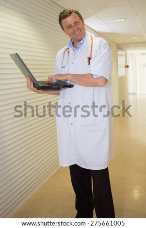 Handsome Doctor at hospital waiting for patient