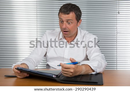Man at his desk happy to find an idea