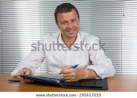 Man at his desk happy to find an idea