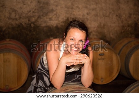 A bride in the wine cellar after her wedding looking at the camera