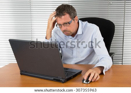 Very handsome man at work behind his laptop