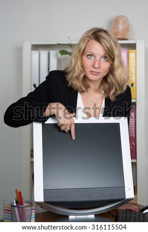 Young blonde business woman presenting screen of computer