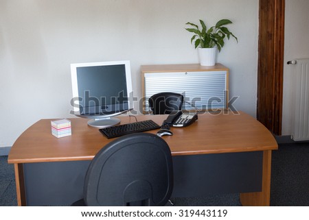 Modern office interior with tables,computer,  chairs and bookcases. Nobody