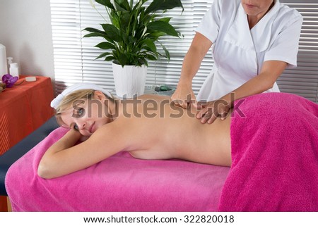 Young attractive woman getting massaging treatment