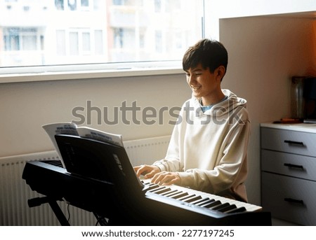 Similar – Image, Stock Photo boy plays piano Piano