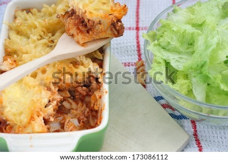 Fusilli pasta baked with minced meat, tomatoes, oregano, basil and cheese dressing, served with fresh lettuce