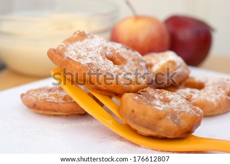 Fried apple in pancake dough or apple fritters with icing sugar and cinnamon