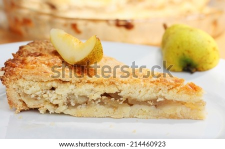 Piece of fresh homemade pear pie with fresh pear slice