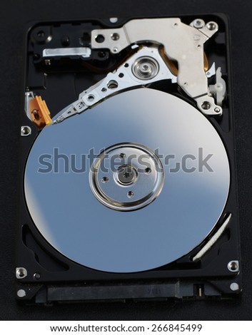Hard disk drive, open, magnetic head and rotating platter visible