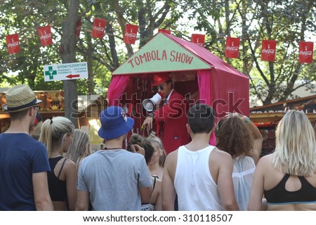 BUDAPEST, HUNGARY - AUGUST 13, 2015: Summer music festival everyday life. Visitors of Sziget music festival enjoy hot weather. Sziget is one of biggest festivals in Europe.
