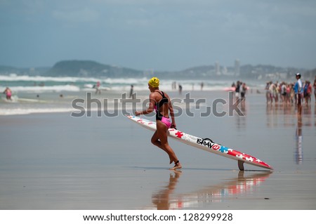 GOLD COAST, SURFERS PARADISE, QLD,  AUSTRALIA - FEB 9. 2013: Maddy Dunn (17) race\'s winner, compete at round four of the Surf Ironwoman Series on February 09th 2013, Gold Coast Australia.