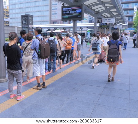 KYOTO JAPAN - 2 JUNE, 2014: Unidentified people queue at Kyoto station bus terminal. Kyoto has a population for 1.5 million and nicknamed as the City of Ten Thousand Shrines.
