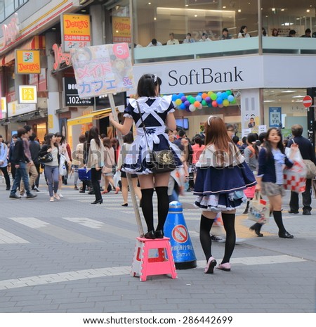 TOKYO JAPAN - MAY 9, 2015: Unidentified girls promote maid cafe in Ikebukuro. Maid cafe is a cosplay restaurant where waitresses dressed in maid costumes.