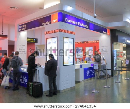 MELBOURNE AUSTRALIA - JUNE 18, 2015: Unidentified people exchange money at Travelex Melbourne Airport - Travelex is a foreign exchange company headquartered in London UK.