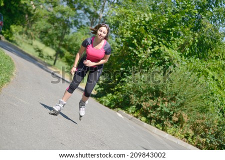 pretty young woman doing roller-skate on a track in the French Alps