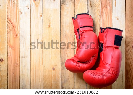 pair of red boxing gloves hanging on the wall