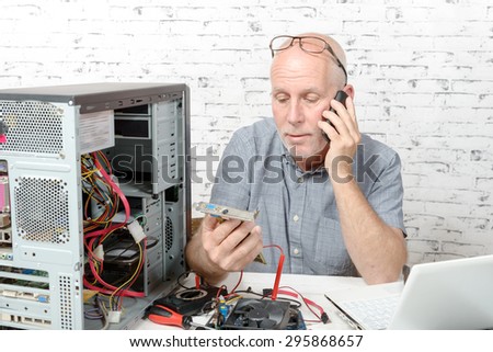 a technician repairing a computer and phone to the customer