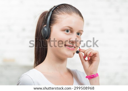 Pretty young smiling woman with a headset