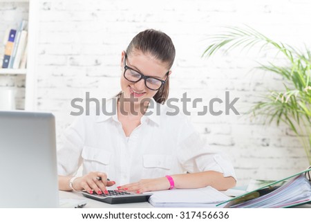 A young secretary working in her office