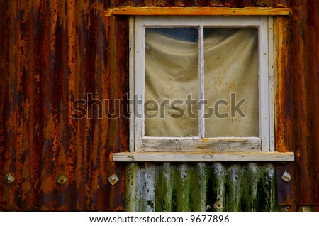 A corroded seaside boat shed window