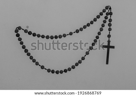 Similar – Image, Stock Photo A rosary hangs from an open Christian prayer book with the Our Father