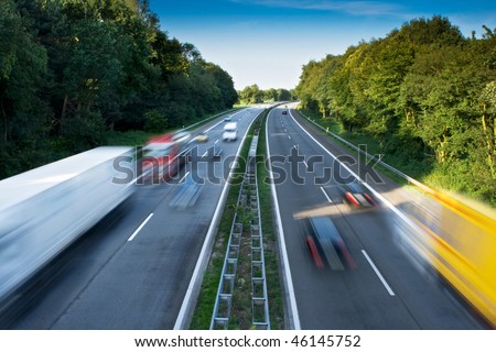 Cars and Trucks on a Motorway. Motion Blur.