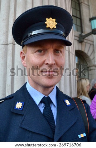 DUBLIN, IRELAND - April 6, 2015: An unidentified policeman on duty outside Dublin city\'s General Post Office (GPO) during the Road to the Rising commemorations on April 6, 2015 in Dublin, Ireland.