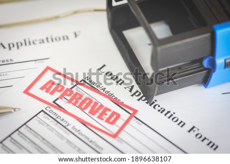 Loan application form with Rubber stamping that says Loan Approved, Financial loan money contract agreement company credit or person - loan approval