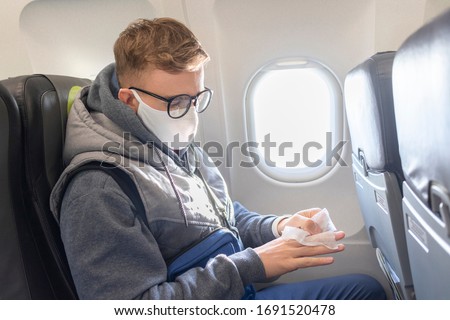 Similar – Image, Stock Photo Serious passengers in protective masks during their train trip