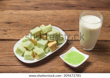 Bread Steam with green honey custard dip and soybean milk Traditional Thai Breakfast food meal in Thailand on wooden texture background