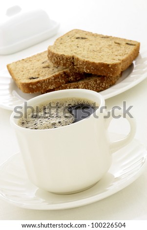 delicious breakfast with fresh hot coffee, butter and whole grain bread.