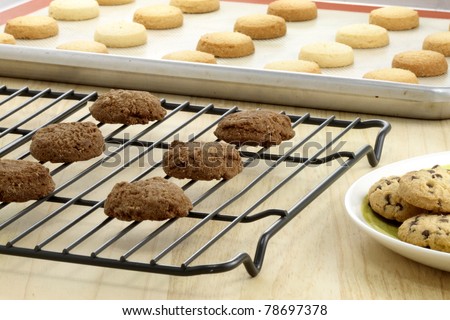 Fresh baked Stack of warm chocolate chips cookies, chocolate cookies and shortbread cookies shallow DOF