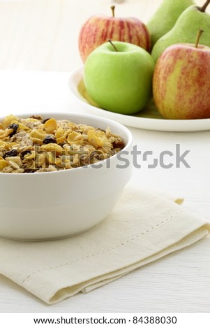 delicious and healthy granola or muesli with fresh organic apples and pears , with lots of dry fruits, nuts and grains.