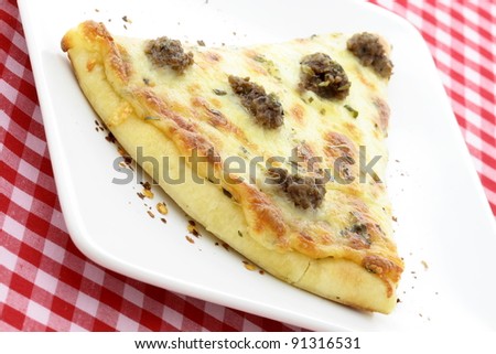delicious rustic meat pizza slice topped with mozzarella cheese,ground beef and marinara sauce