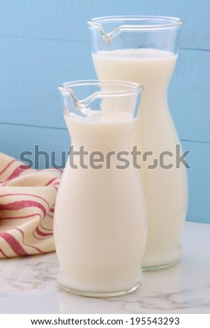 Delicious fresh milk, one of the primary sources of nutrition on vintage Italian carrara marble, farm styling kitchen.