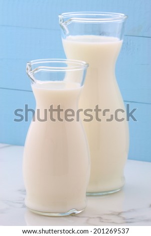Delicious fresh milk, one of the primary sources of nutrition on vintage Italian carrara marble, farm styling kitchen.