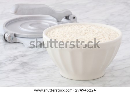 nixtamalized mexican corn flour on carrara marble pastry board