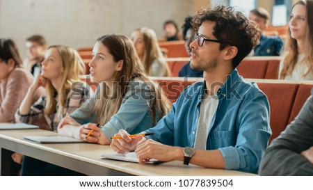 In the Classroom Multi Ethnic Students Listening to a Lecturer and Writing in Notebooks. Smart Young People Study at the College. Imagine de stoc © 