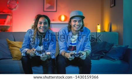 Similar – Image, Stock Photo Happy girl playing video games at night