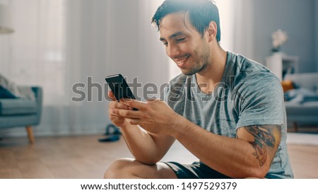 Similar – Image, Stock Photo Athletic man using his mobile phone.