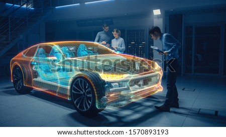 Group of Automobile Design Engineers Working in Virtual Reality 3D Model Prototype of Electric Car Chassis. Automotive Innovation Facility: 3D Concept Vehicle Generated with 3D CAD Software.