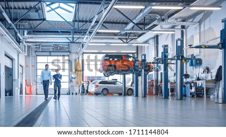 Similar – Foto Bild Automechaniker bei der Arbeit an einem Automotor in einer Autowerkstatt. Reparatur Service. authentische Nahaufnahme Schuss