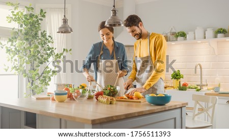 Similar – Image, Stock Photo Couple preparing food in kitchen.