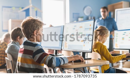 Elementary School Computer Science Classroom: Smart Little Schoolboy Work on Personal Computers, Learn Programming Language for Software Coding. Schoolchildren Getting Modern Education