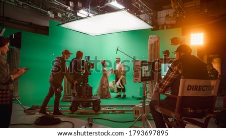 On Big Film Studio Professional Crew Shooting History Costume Drama Movie. On Set: Director Controls Cameraman Shooting Green Screen Scene with Two Actors Talented Wearing Renaissance Clothes Talking