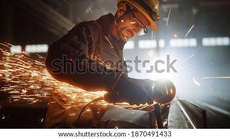 Similar – Image, Stock Photo Industrial worker using angle grinder grinding metal on welding seams. Worker working with angle grinder and has sparks. Tool for cut steel. Safety in industrial workplace. Metal factory industry.